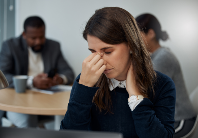 An employee stressed without proper wellness support.